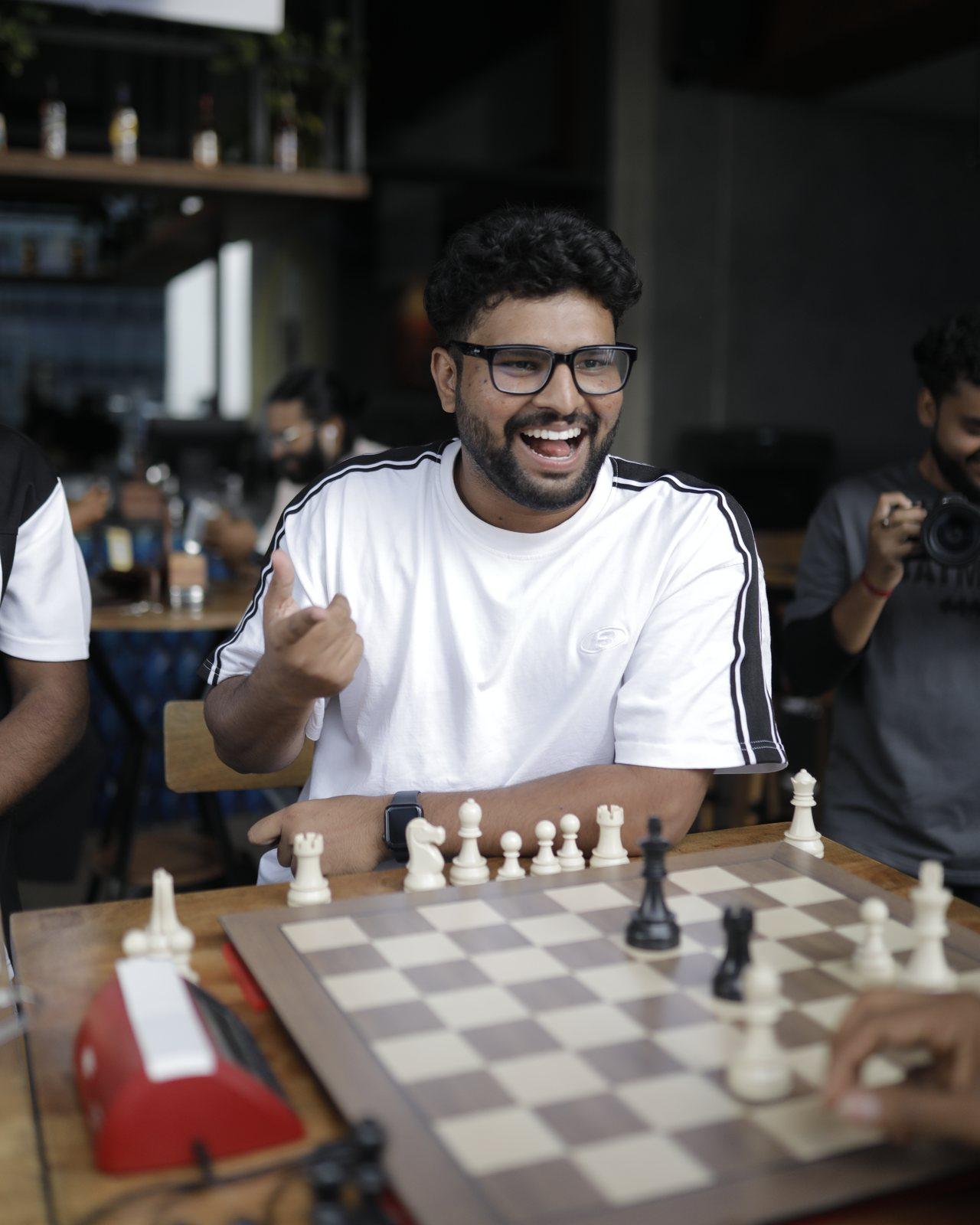 Suyog Wagh laughing during a game of chess