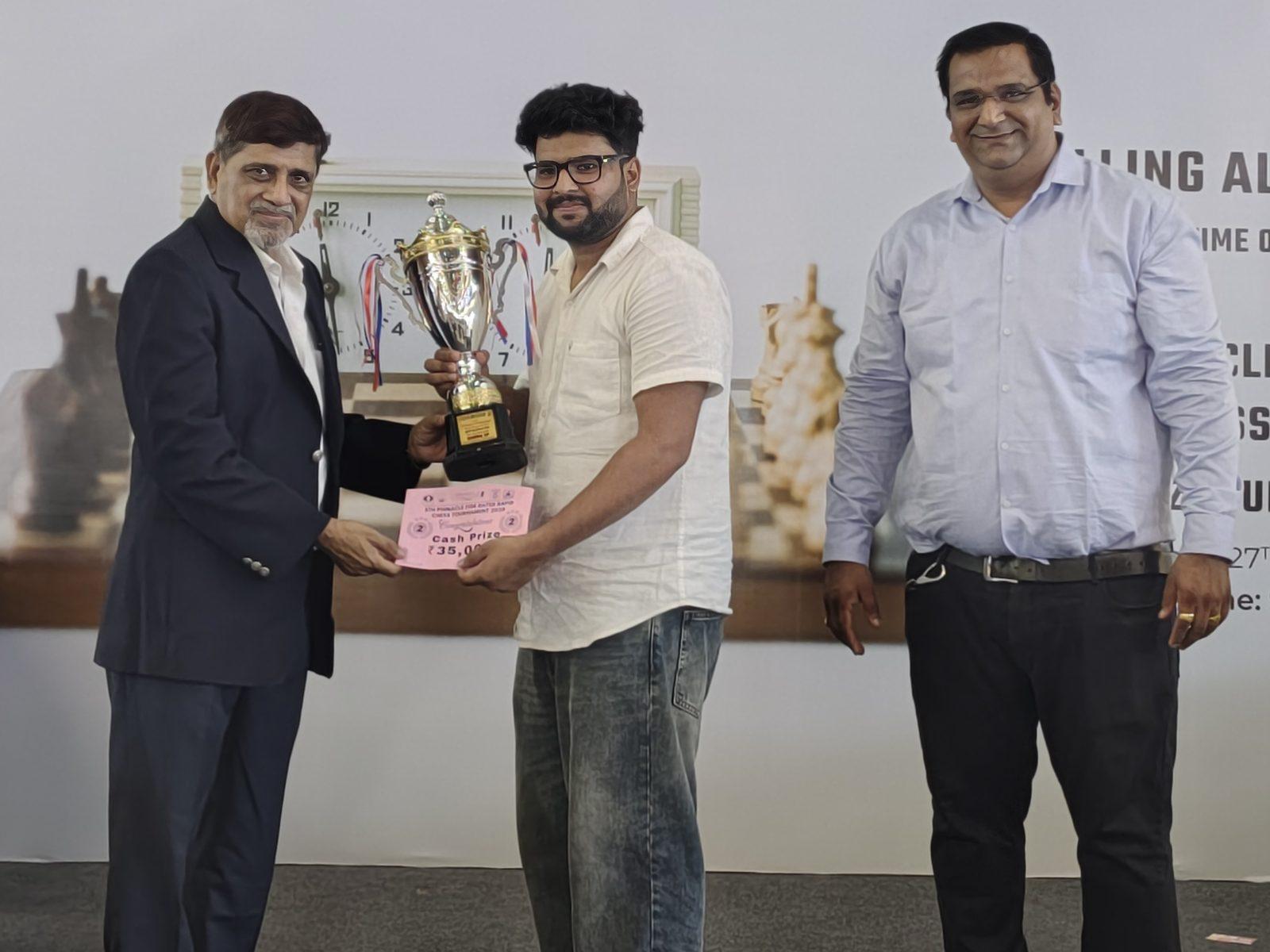 Suyog Wagh receiving a winner’s trophy at a Pinnacle Chess Events rapid tournament