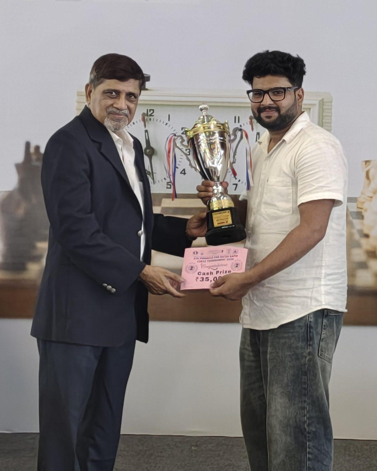 Suyog Wagh holding a winner’s trophy at a Pinnacle Chess Events rapid tournament
